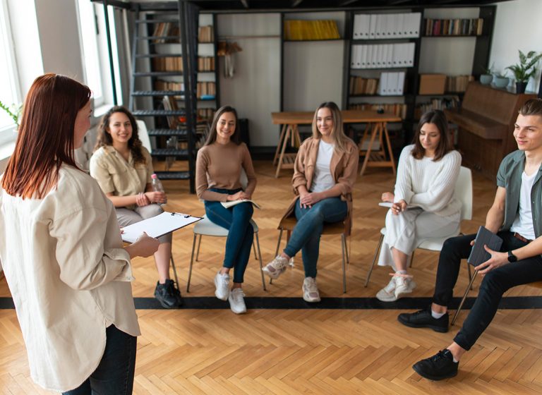 medium-shot-people-sitting-chairs.jpg